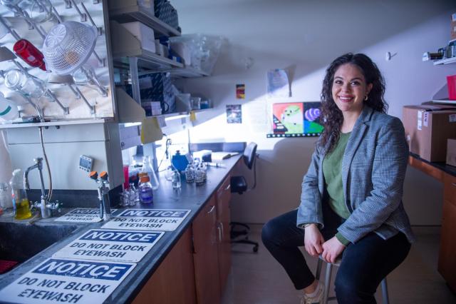 Three-Minute Thesis winner Emily Schmitz. Schmitz, a PhD student at Iowa sits in her lab. 