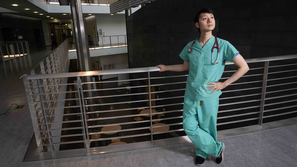 Thomas Pak poses in scrubs and stethoscope